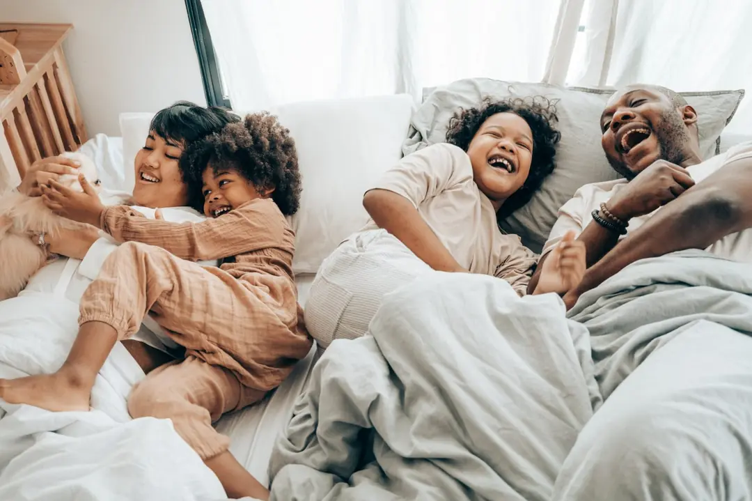 Family relaxing in a cool bedroom